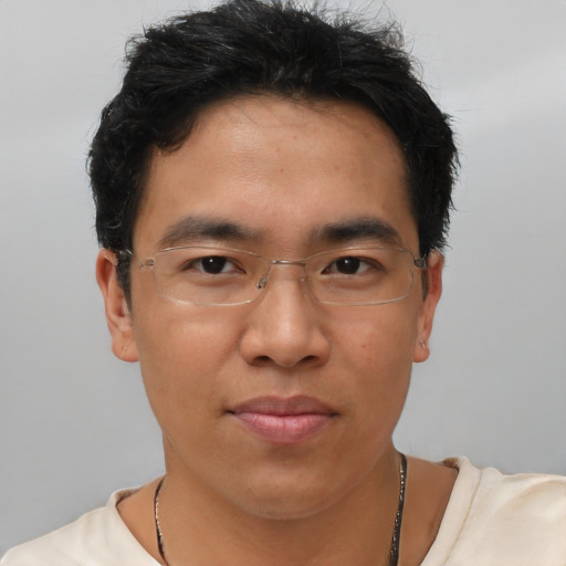 Joyful asian young-adult male with short  brown hair and brown eyes
