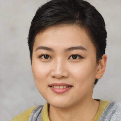 Joyful asian young-adult female with short  brown hair and brown eyes
