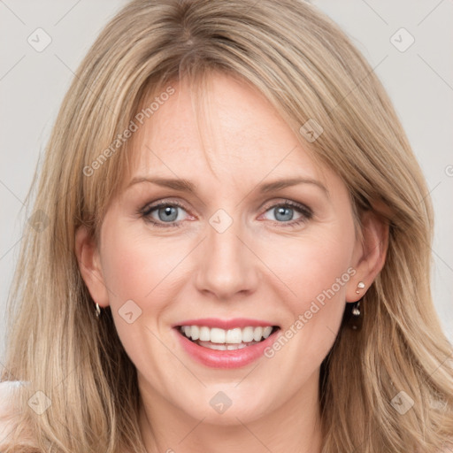 Joyful white young-adult female with long  brown hair and blue eyes