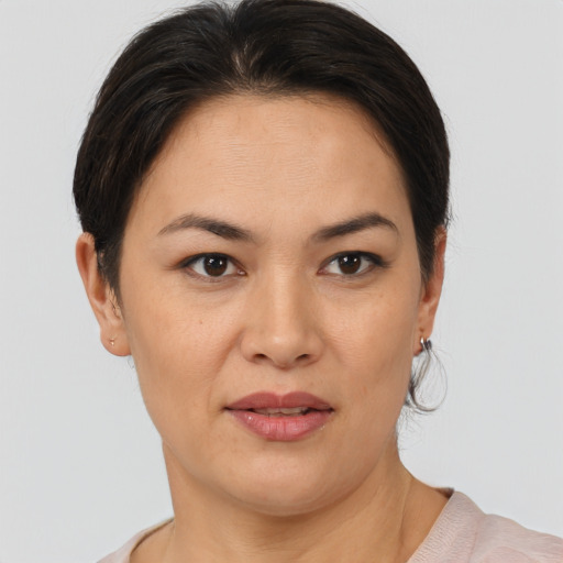 Joyful latino adult female with short  brown hair and brown eyes