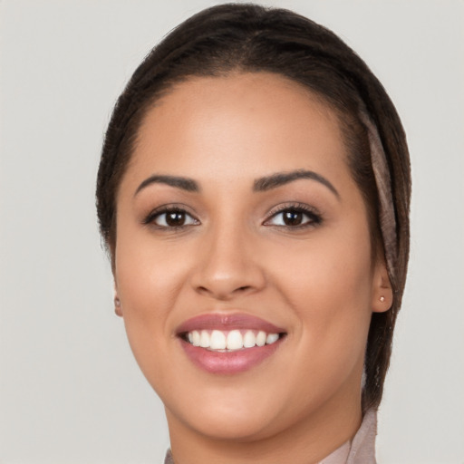 Joyful white young-adult female with long  brown hair and brown eyes