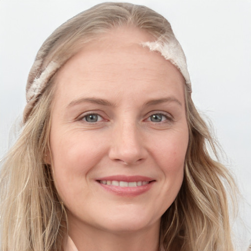 Joyful white young-adult female with long  brown hair and blue eyes