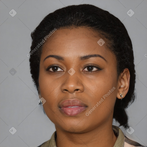 Joyful black young-adult female with medium  black hair and brown eyes