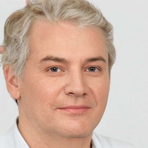 Joyful white adult male with short  brown hair and grey eyes