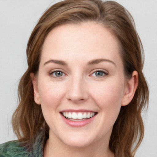 Joyful white young-adult female with long  brown hair and blue eyes