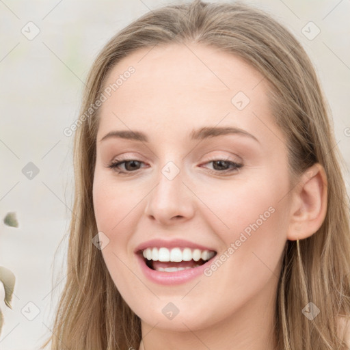 Joyful white young-adult female with long  brown hair and blue eyes