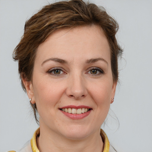 Joyful white young-adult female with medium  brown hair and blue eyes