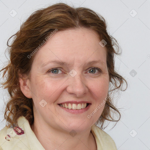 Joyful white adult female with medium  brown hair and blue eyes