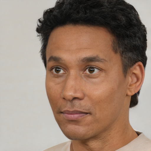 Neutral black adult male with short  black hair and brown eyes