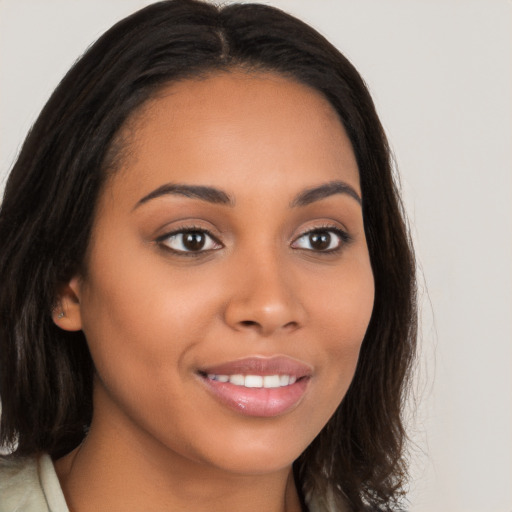 Joyful latino young-adult female with long  brown hair and brown eyes