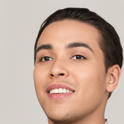 Joyful white young-adult male with short  black hair and brown eyes