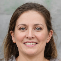 Joyful white young-adult female with medium  brown hair and grey eyes