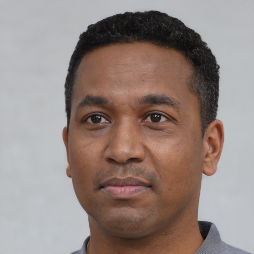 Neutral black young-adult male with short  black hair and brown eyes