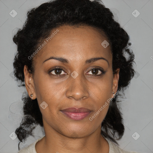 Joyful black adult female with medium  brown hair and brown eyes