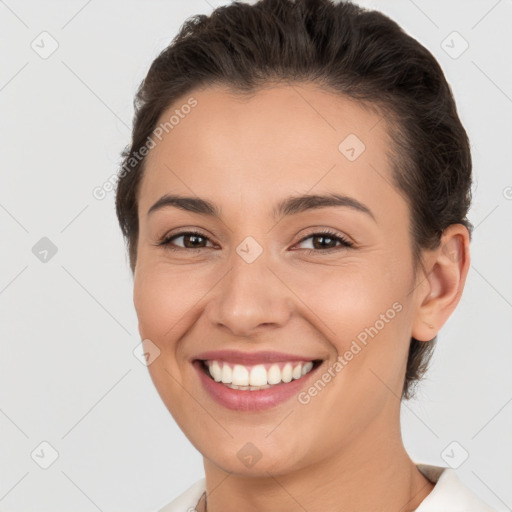 Joyful white young-adult female with short  brown hair and brown eyes