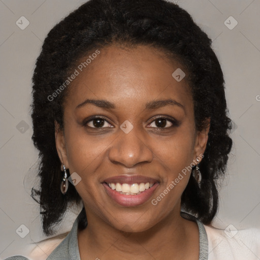 Joyful black young-adult female with long  brown hair and brown eyes