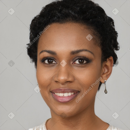 Joyful black young-adult female with short  black hair and brown eyes