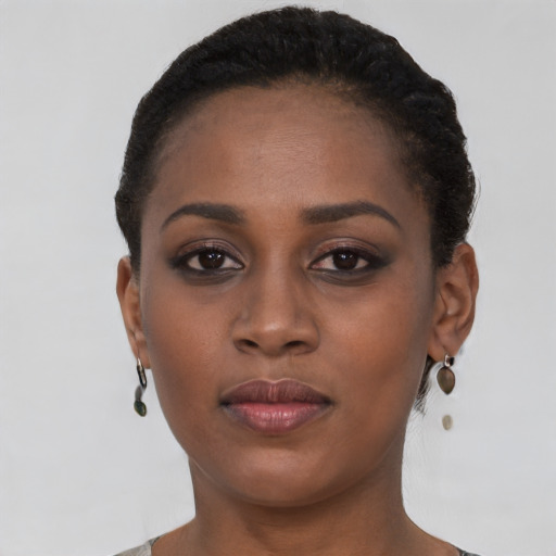 Joyful black young-adult female with short  brown hair and brown eyes