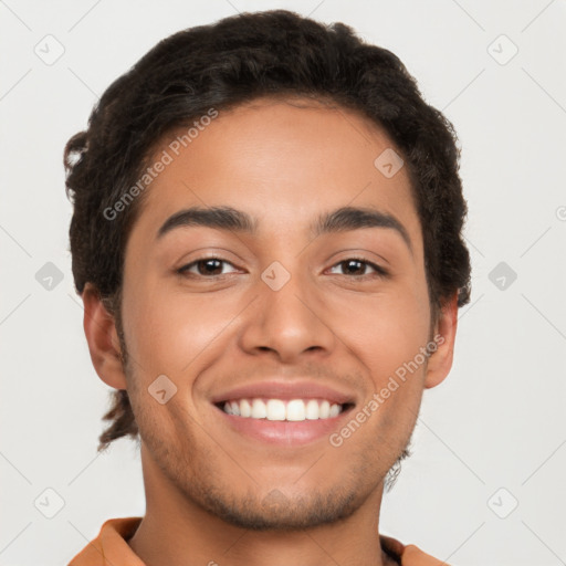 Joyful latino young-adult male with short  brown hair and brown eyes