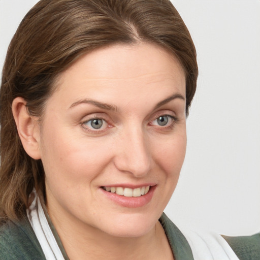 Joyful white young-adult female with medium  brown hair and blue eyes