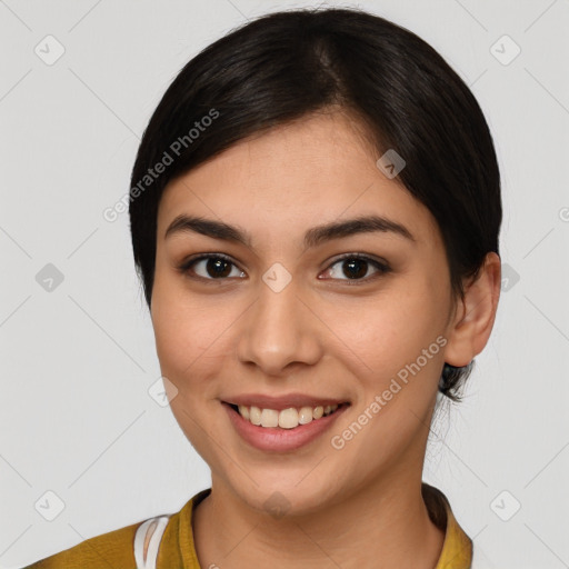 Joyful latino young-adult female with medium  brown hair and brown eyes