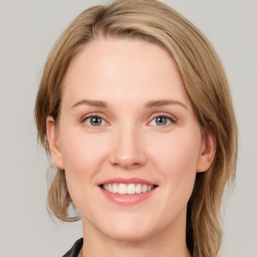 Joyful white young-adult female with medium  brown hair and blue eyes