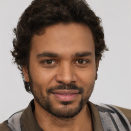 Joyful black young-adult male with short  brown hair and brown eyes