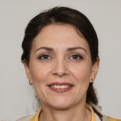 Joyful white adult female with medium  brown hair and grey eyes