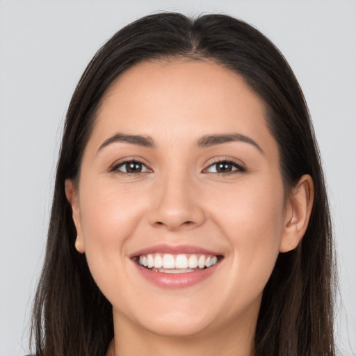 Joyful white young-adult female with long  brown hair and brown eyes