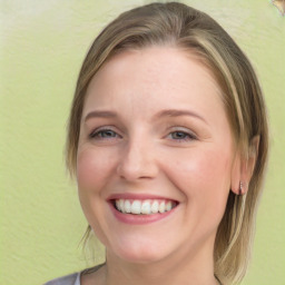 Joyful white young-adult female with medium  brown hair and blue eyes