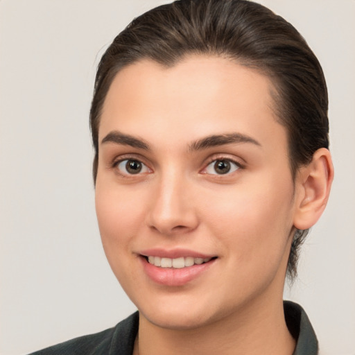 Joyful white young-adult female with medium  brown hair and brown eyes