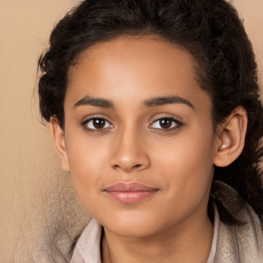 Joyful latino young-adult female with long  brown hair and brown eyes