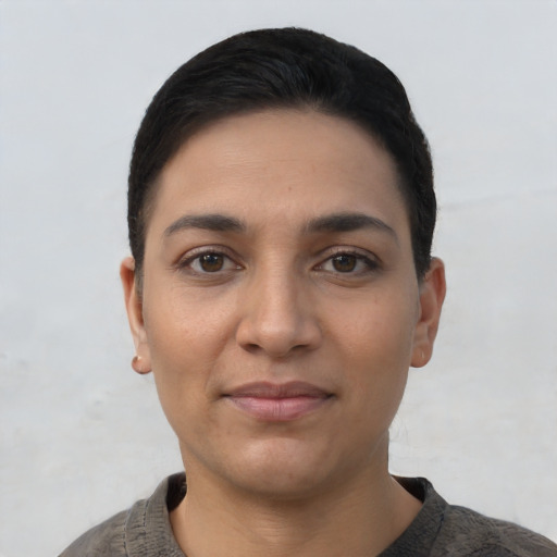 Joyful latino young-adult female with short  black hair and brown eyes