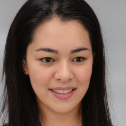 Joyful asian young-adult female with long  brown hair and brown eyes