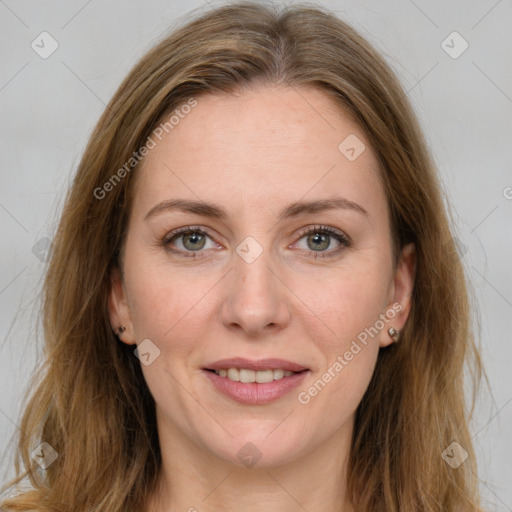 Joyful white adult female with long  brown hair and green eyes