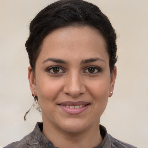 Joyful white young-adult female with short  brown hair and brown eyes