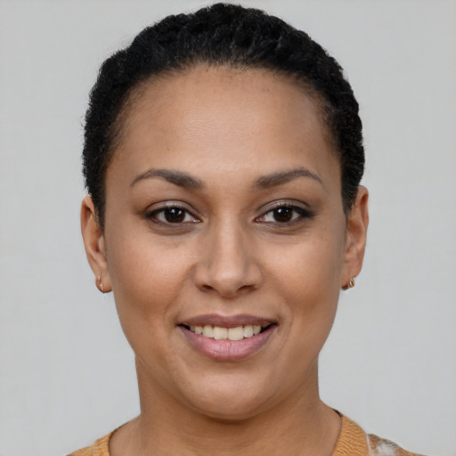 Joyful latino young-adult female with short  black hair and brown eyes