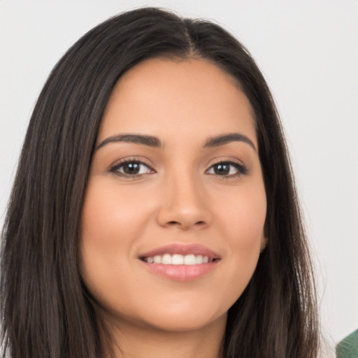 Joyful white young-adult female with long  brown hair and brown eyes