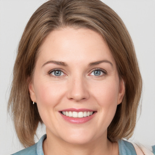 Joyful white young-adult female with medium  brown hair and blue eyes