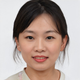 Joyful asian young-adult female with medium  brown hair and brown eyes