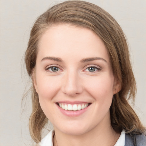 Joyful white young-adult female with medium  brown hair and blue eyes