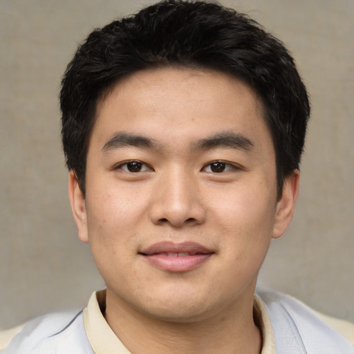 Joyful asian young-adult male with short  black hair and brown eyes