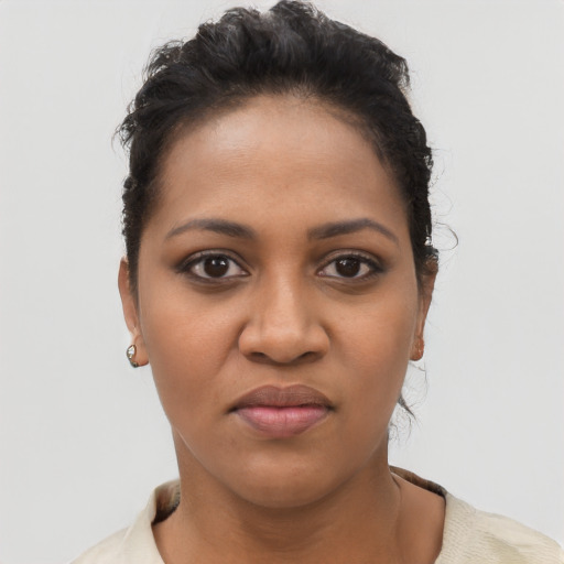 Joyful latino young-adult female with short  black hair and brown eyes