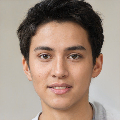 Joyful asian young-adult male with short  brown hair and brown eyes