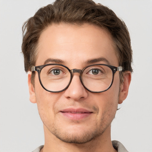 Joyful white adult male with short  brown hair and grey eyes