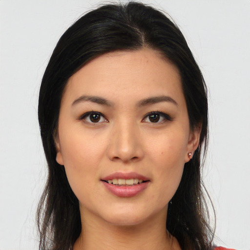 Joyful asian young-adult female with long  black hair and brown eyes