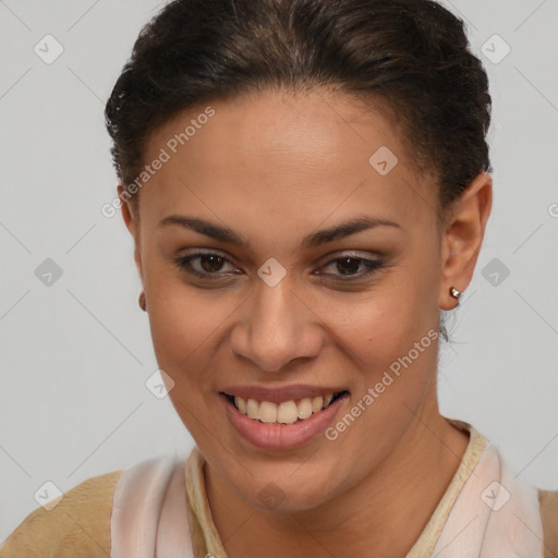 Joyful black young-adult female with short  brown hair and brown eyes