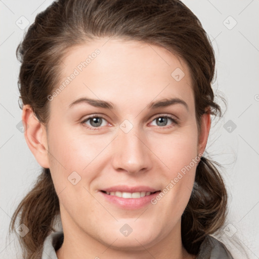 Joyful white young-adult female with medium  brown hair and grey eyes