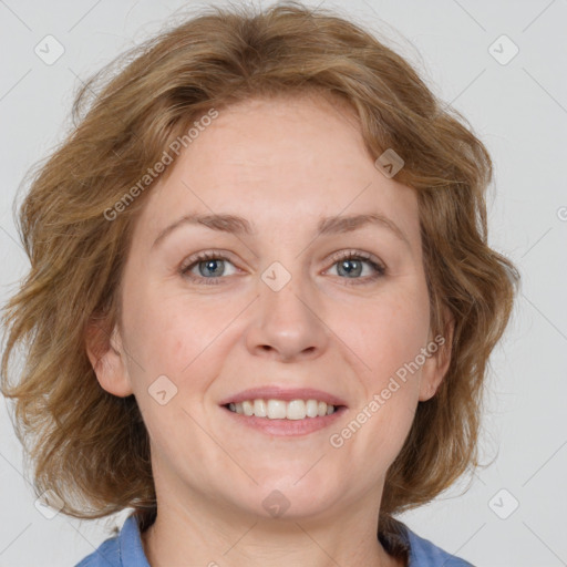 Joyful white adult female with medium  brown hair and blue eyes