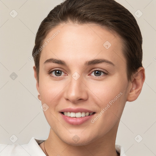 Joyful white young-adult female with short  brown hair and brown eyes